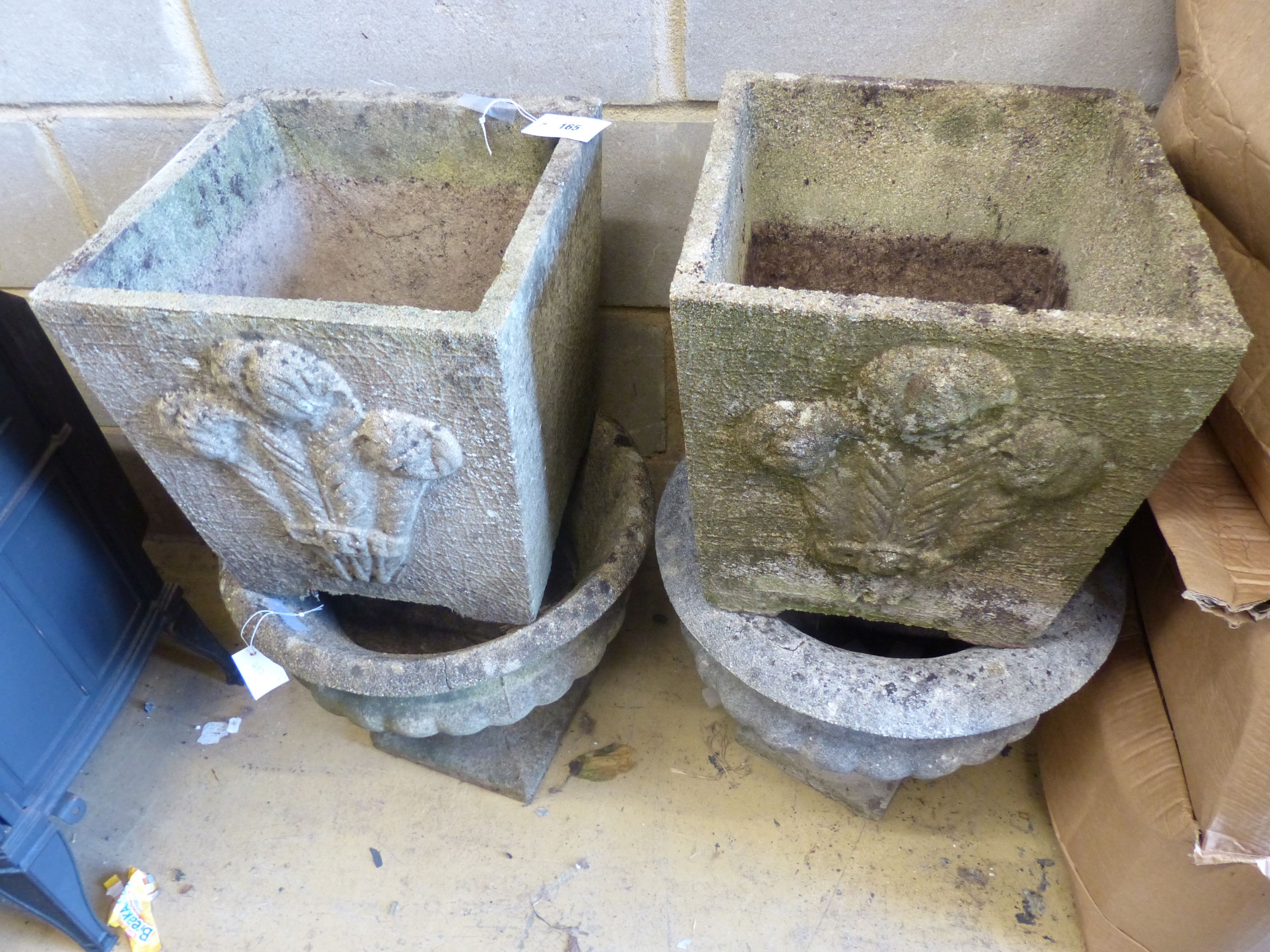 Two pairs of reconstituted stone garden planters, larger 36cm high